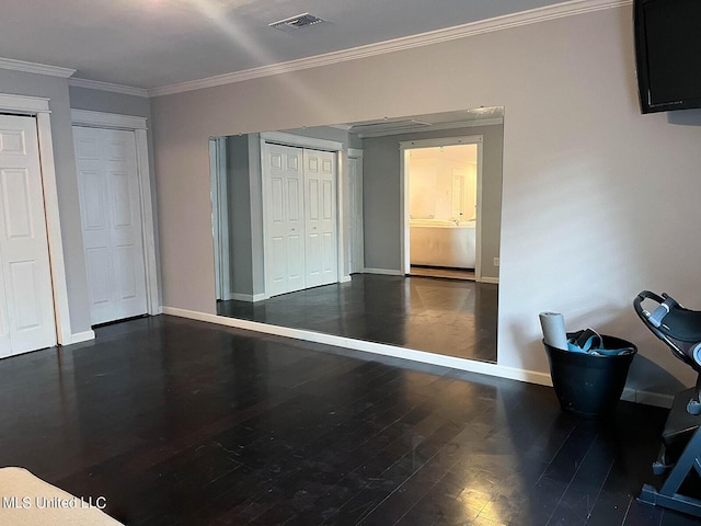 106 Piney Ridge Rd, Waveland, MS 39576 - unfurnished bedroom featuring visible vents, wood finished floors, baseboards, multiple closets, and ornamental molding