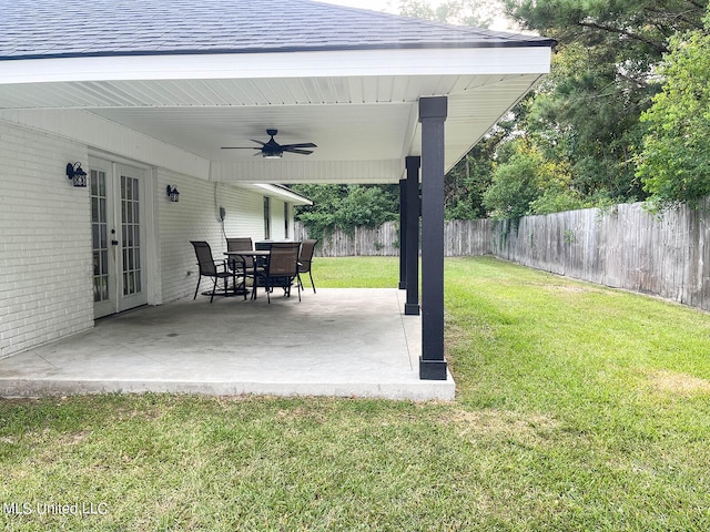 view of yard featuring french doors, ceiling fan, and a patio area