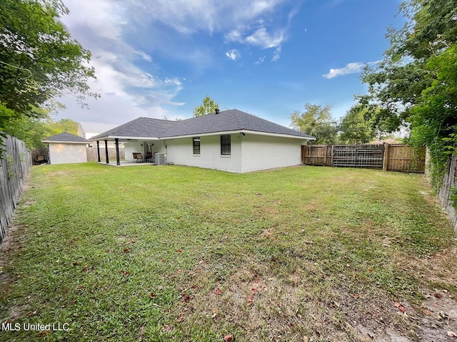 106 Piney Ridge Rd, Waveland, MS 39576 - back of house with a lawn, a fenced backyard, a patio area, and central AC