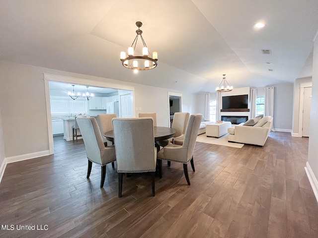 dining area with hardwood / wood-style floors and vaulted ceiling