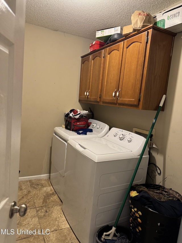 127 Nichols Blvd, Senatobia, MS 38668 - laundry area with cabinet space, independent washer and dryer, a textured ceiling, and light stone finish floors