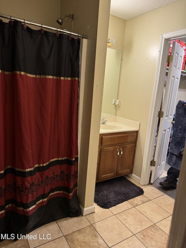 127 Nichols Blvd, Senatobia, MS 38668 - bathroom with a textured ceiling, vanity, tile patterned flooring, and a shower with curtain