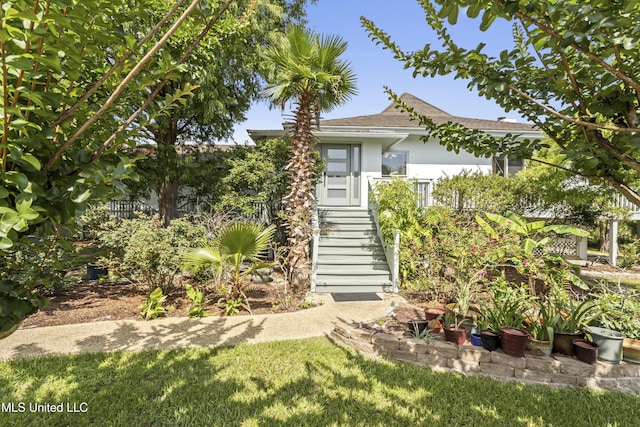 420 N Caribe Pl, Gulfport, MS 39507 - view of property hidden behind natural elements featuring stucco siding, roof with shingles, and stairs