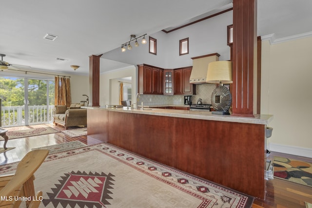 420 N Caribe Pl, Gulfport, MS 39507 - kitchen featuring a ceiling fan, hardwood / wood-style flooring, open floor plan, tasteful backsplash, and ornamental molding