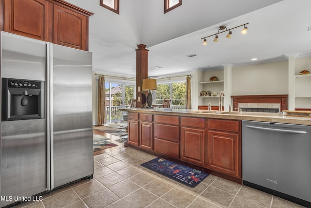 420 N Caribe Pl, Gulfport, MS 39507 - kitchen with appliances with stainless steel finishes, a sink, decorative columns, ornamental molding, and built in shelves