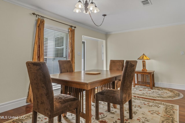 420 N Caribe Pl, Gulfport, MS 39507 - dining space with a chandelier, baseboards, ornamental molding, and wood finished floors