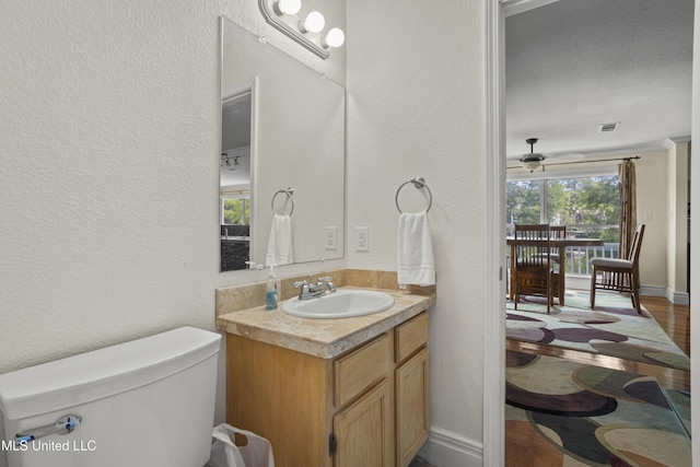 420 N Caribe Pl, Gulfport, MS 39507 - bathroom featuring toilet, vanity, a textured wall, and wood finished floors