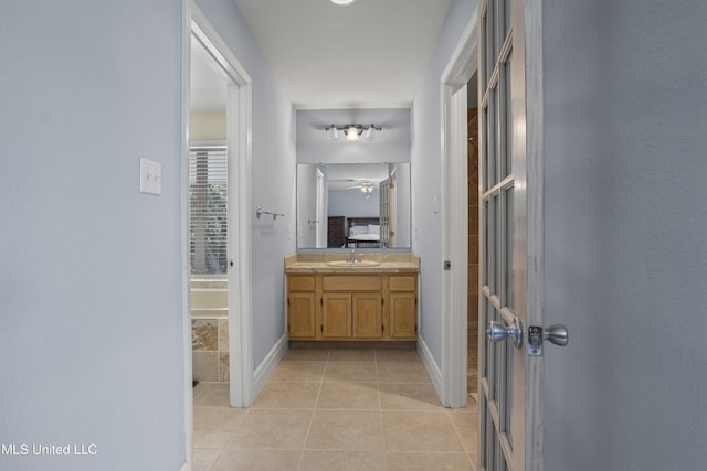 420 N Caribe Pl, Gulfport, MS 39507 - bathroom with vanity, tile patterned flooring, baseboards, and ceiling fan