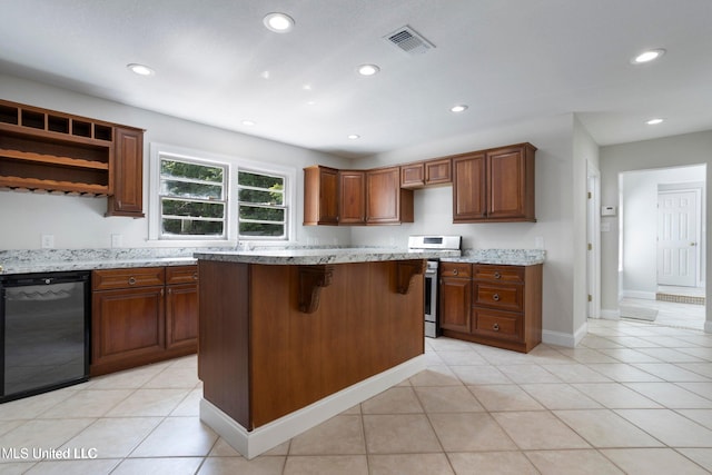 kitchen with light tile patterned flooring, a kitchen island, stainless steel stove, a breakfast bar area, and light stone countertops