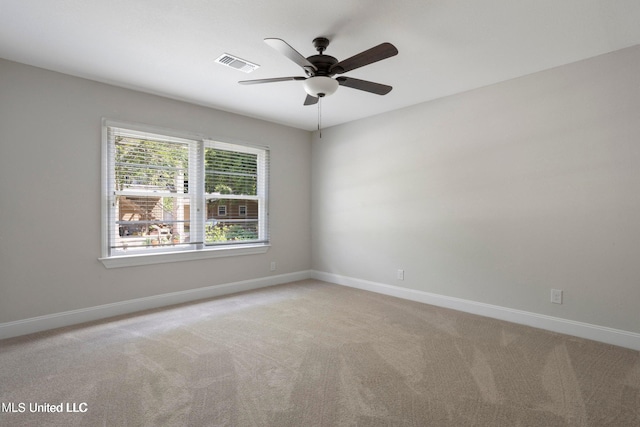 carpeted empty room featuring ceiling fan