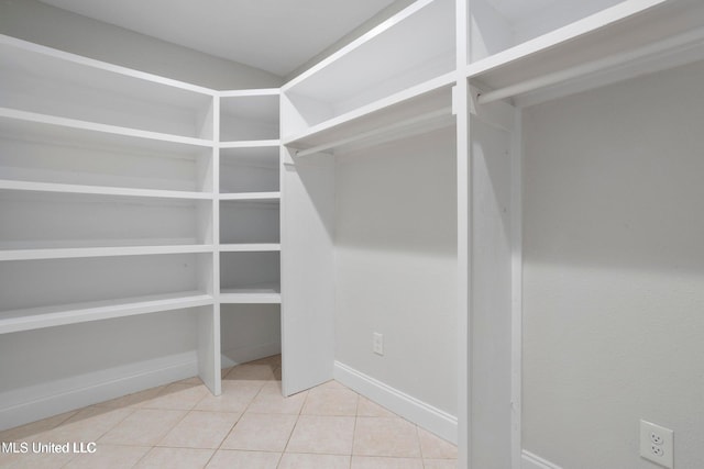 walk in closet with tile patterned flooring