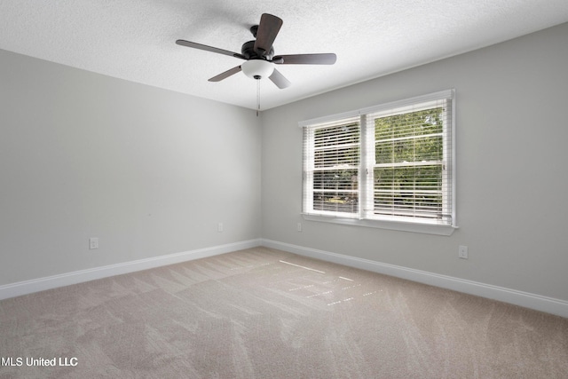 unfurnished room featuring ceiling fan, light colored carpet, and a textured ceiling