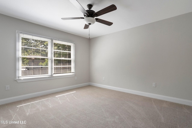 unfurnished room featuring light colored carpet and ceiling fan