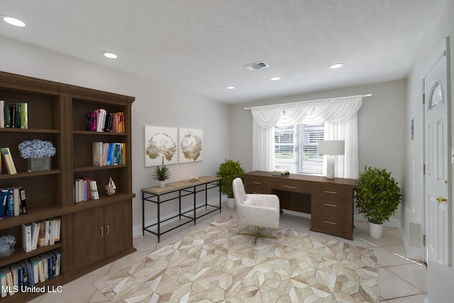 tiled office with a textured ceiling