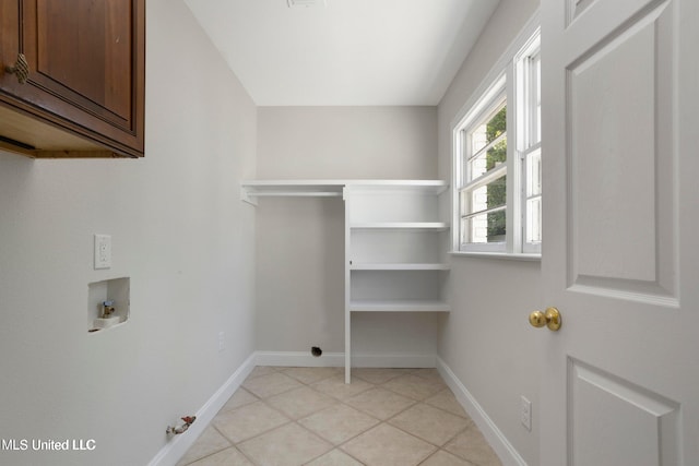 laundry room featuring cabinets, hookup for a gas dryer, hookup for a washing machine, and light tile patterned floors