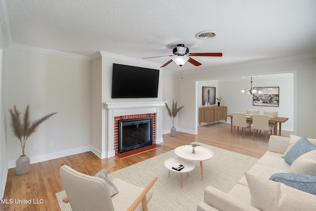 living room featuring hardwood / wood-style floors, a fireplace, and ornamental molding