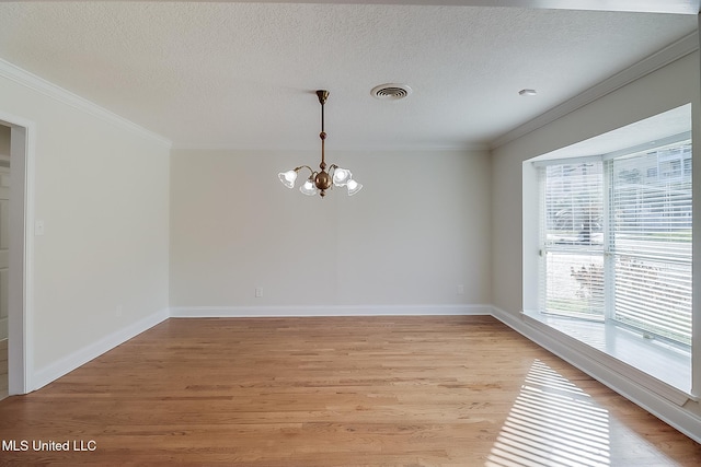 unfurnished room with ornamental molding, light wood-type flooring, and a chandelier