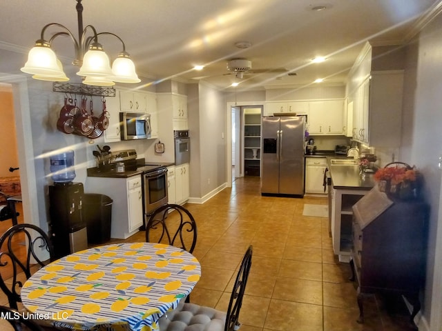 701 W Gresham St, Indianola, MS 38751 - kitchen with white cabinetry, pendant lighting, crown molding, and stainless steel appliances