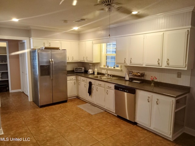 701 W Gresham St, Indianola, MS 38751 - kitchen featuring white cabinets, sink, light tile patterned flooring, crown molding, and appliances with stainless steel finishes