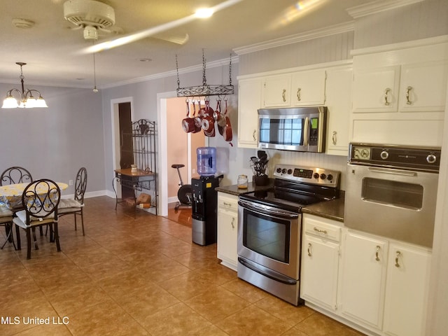 701 W Gresham St, Indianola, MS 38751 - kitchen featuring an inviting chandelier, hanging light fixtures, ornamental molding, white cabinetry, and appliances with stainless steel finishes