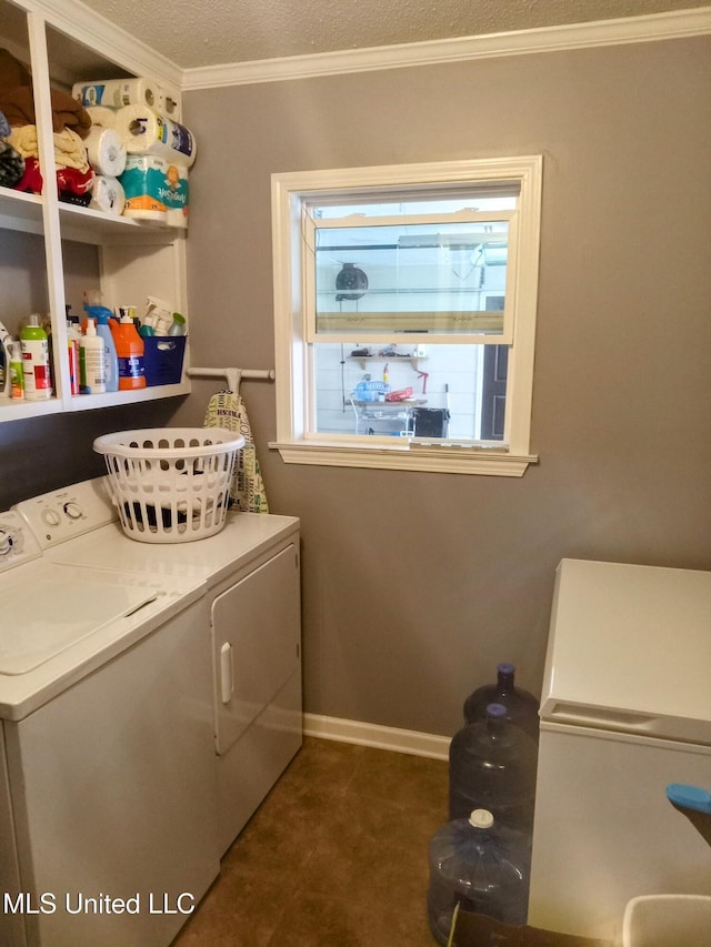 701 W Gresham St, Indianola, MS 38751 - washroom with plenty of natural light, a textured ceiling, crown molding, and washing machine and clothes dryer