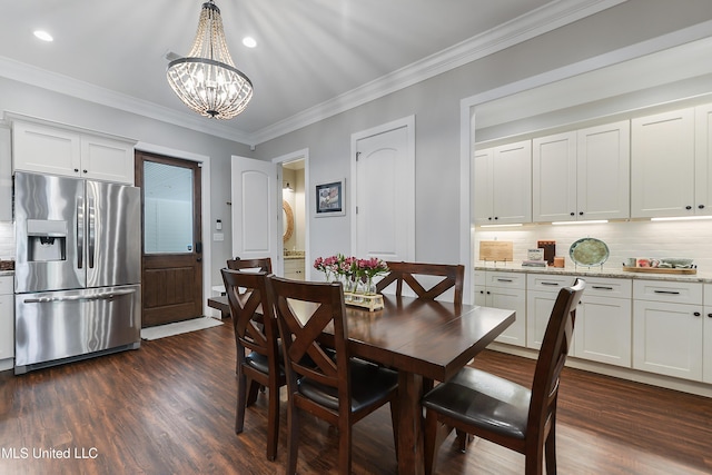 802 Old Spanish Trl, Bay Saint Louis, MS 39520 - dining space featuring a chandelier, dark wood-style floors, crown molding, and recessed lighting