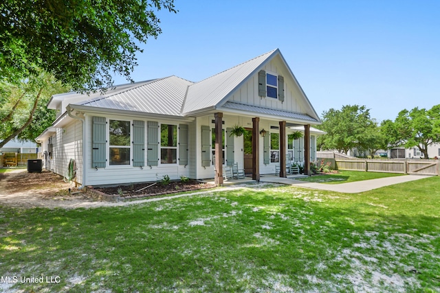 802 Old Spanish Trl, Bay Saint Louis, MS 39520 - modern farmhouse with board and batten siding, a porch, central AC unit, and metal roof