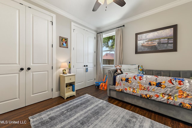 802 Old Spanish Trl, Bay Saint Louis, MS 39520 - bedroom featuring dark wood-type flooring, crown molding, multiple closets, and ceiling fan