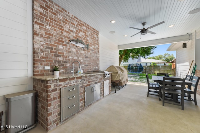 802 Old Spanish Trl, Bay Saint Louis, MS 39520 - view of patio / terrace featuring an outdoor kitchen, a ceiling fan, fence, outdoor dining space, and a sink
