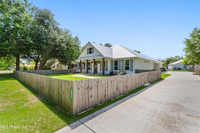 802 Old Spanish Trl, Bay Saint Louis, MS 39520 - view of front of house with a porch and metal roof