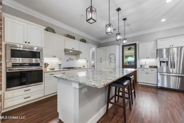 802 Old Spanish Trl, Bay Saint Louis, MS 39520 - kitchen with appliances with stainless steel finishes, a sink, dark wood-style flooring, recessed lighting, and under cabinet range hood