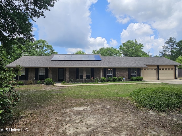 14162 E Marcie Rd, Gulfport, MS 39503 - view of front facade featuring covered porch, driveway, solar panels, a front yard, and an attached garage
