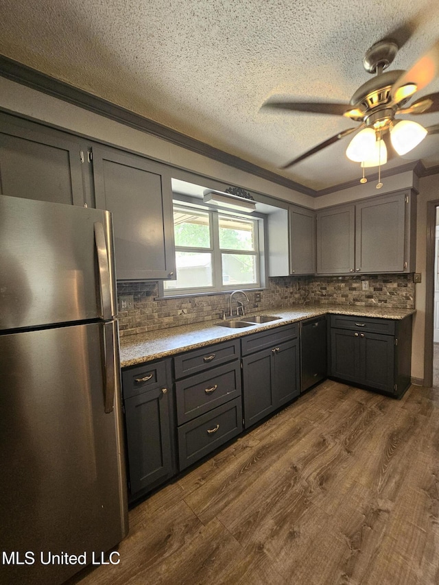 14162 E Marcie Rd, Gulfport, MS 39503 - kitchen with freestanding refrigerator, black dishwasher, dark wood-style floors, a textured ceiling, and a sink