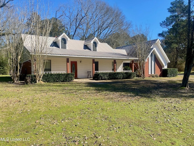 view of front facade featuring a front yard, covered porch, and metal roof