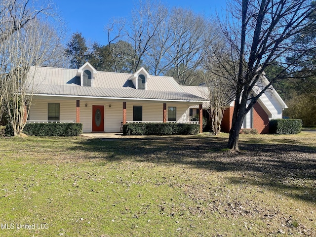 view of front of house featuring a porch, a front yard, and metal roof