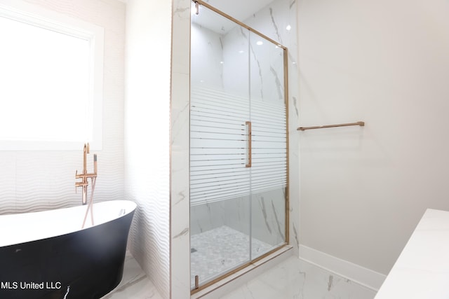138 Genoa Dr, Madison, MS 39110 - bathroom featuring a marble finish shower, a freestanding tub, marble finish flooring, and baseboards