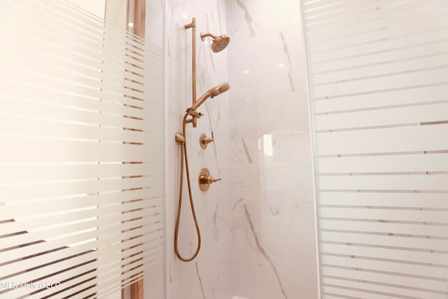 interior details with a tile shower