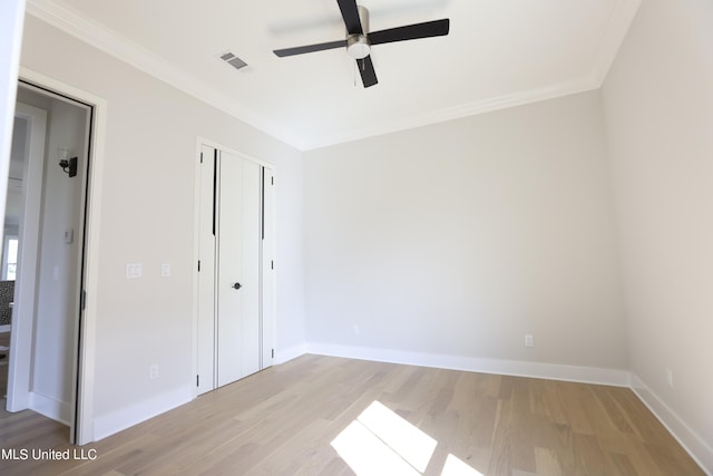 unfurnished bedroom with a closet, ceiling fan, ornamental molding, and light hardwood / wood-style flooring