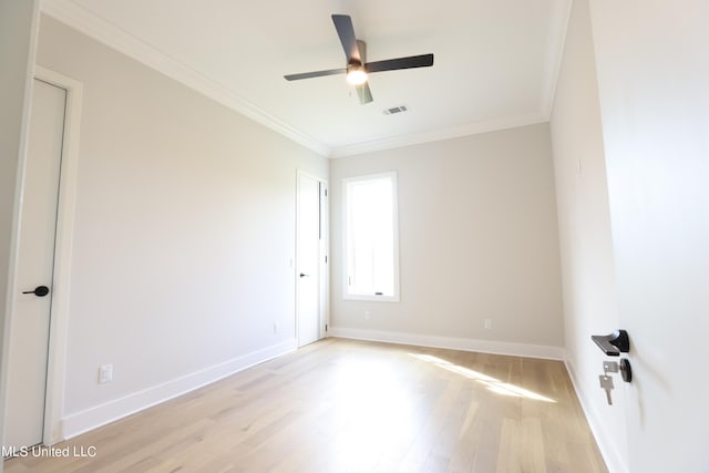 spare room with crown molding, light hardwood / wood-style floors, and ceiling fan