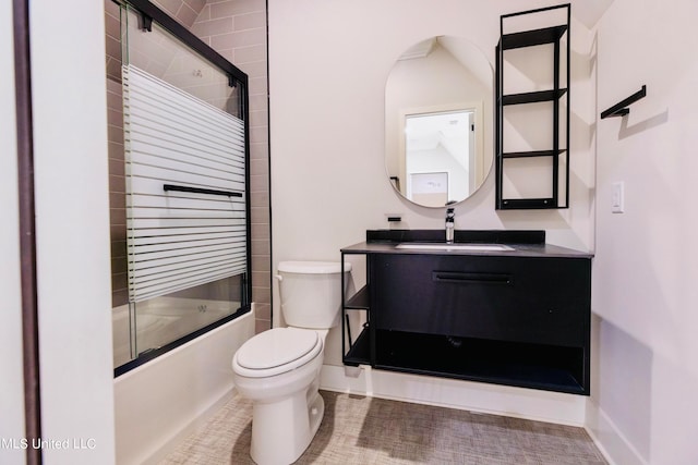 full bathroom with toilet, enclosed tub / shower combo, and vanity