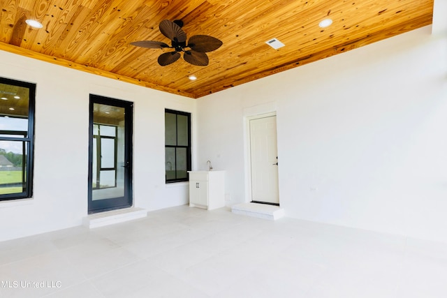 unfurnished room with ceiling fan and wooden ceiling