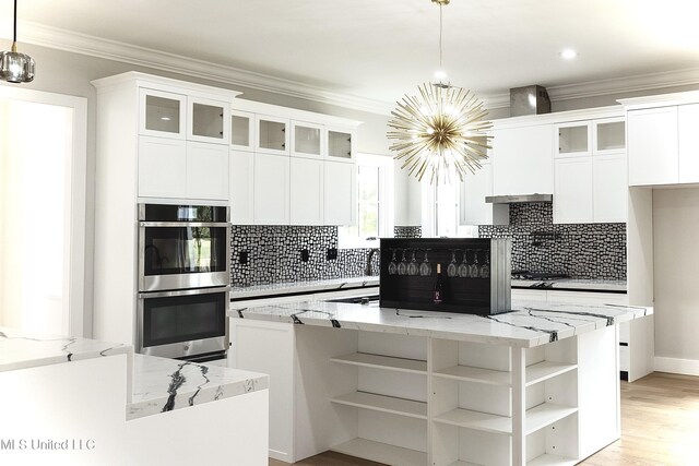 138 Genoa Dr, Madison, MS 39110 - kitchen featuring open shelves, appliances with stainless steel finishes, a kitchen island, crown molding, and a chandelier