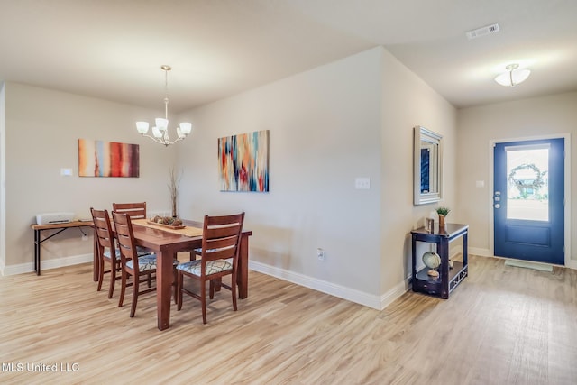 5251 Fairbury Way, Diberville, MS 39540 - dining room with light wood finished floors, a chandelier, and baseboards