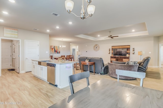 5251 Fairbury Way, Diberville, MS 39540 - kitchen with a sink, a chandelier, white cabinets, a raised ceiling, and a kitchen island with sink