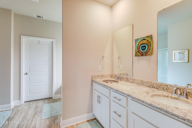 bathroom with hardwood / wood-style floors and vanity