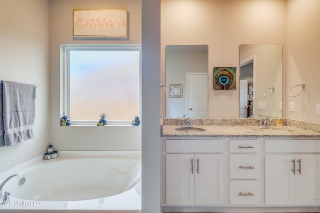 bathroom with a bath and vanity