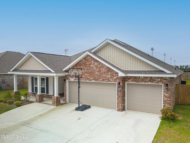 5251 Fairbury Way, Diberville, MS 39540 - craftsman-style home with a shingled roof, concrete driveway, a garage, brick siding, and board and batten siding