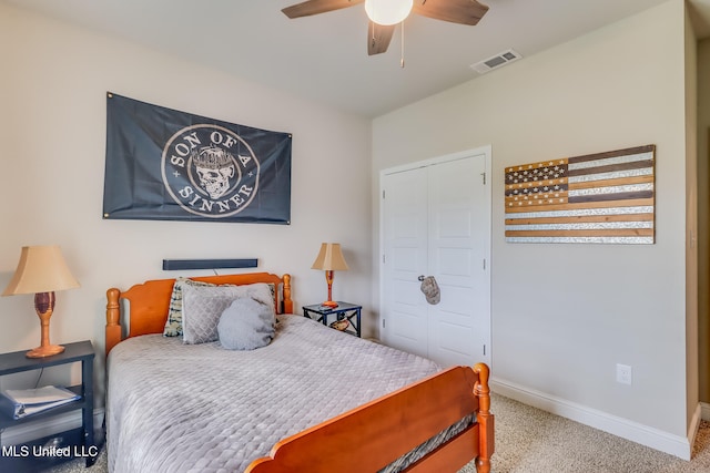 carpeted bedroom with ceiling fan and a closet