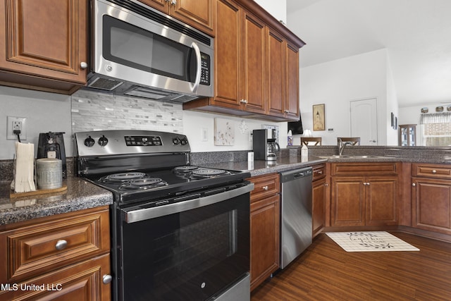13703 Windwood Dr, Gulfport, MS 39503 - kitchen with appliances with stainless steel finishes, dark wood-type flooring, a sink, and brown cabinets