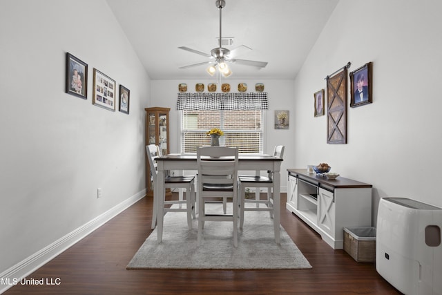 13703 Windwood Dr, Gulfport, MS 39503 - dining room featuring lofted ceiling, dark wood-style flooring, ceiling fan, and baseboards